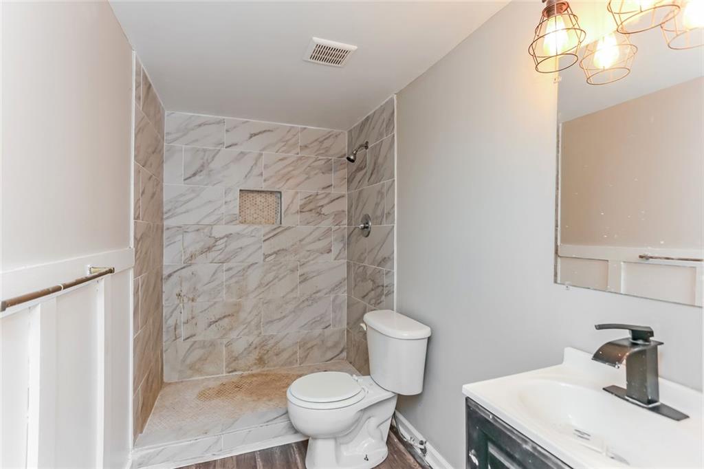 4179 Williamson Road Ellenwood, GA 30294 - Photo 20 of 25 a bathroom with a sink a toilet and shower
