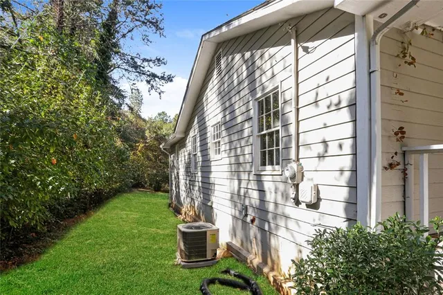 a view of backyard with barbeque grill and wooden fence