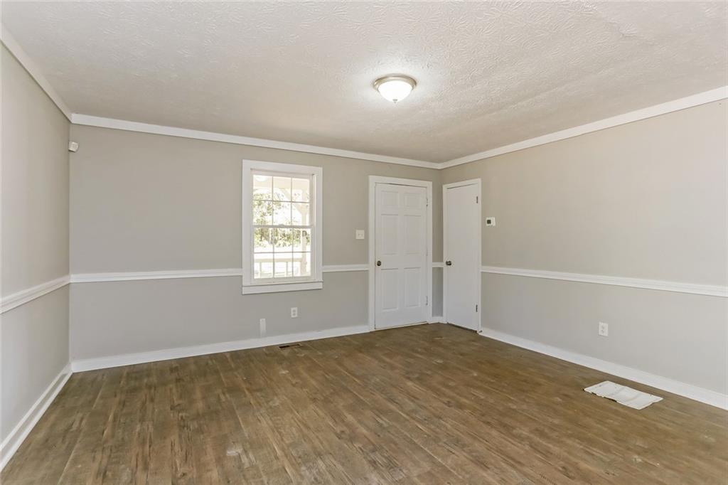 4179 Williamson Road Ellenwood, GA 30294 - Photo 5 of 25 a view of an empty room with wooden floor and a window