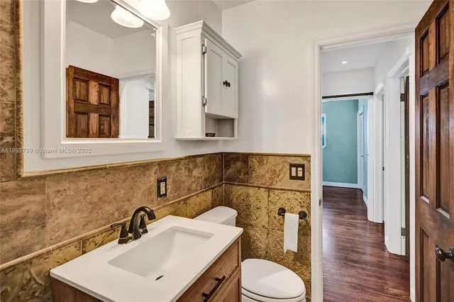 a bathroom with a sink toilet and mirror