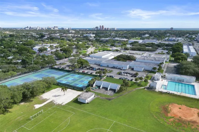 an aerial view of residential houses with outdoor space