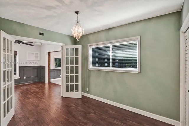a view of a livingroom with wooden floor and a ceiling fan