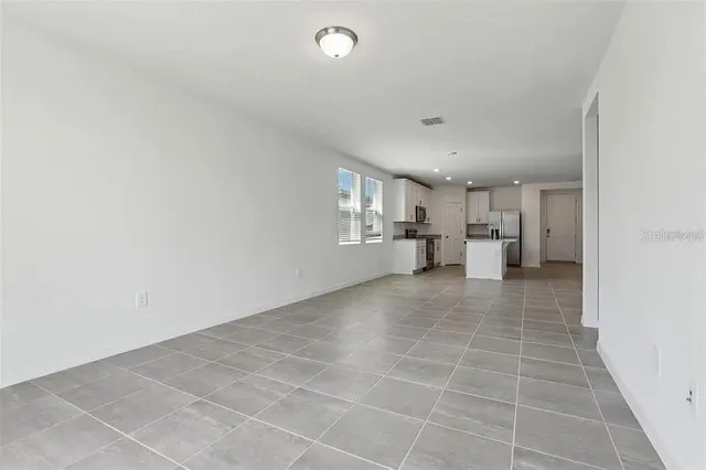 a view of a kitchen with a sink and a refrigerator