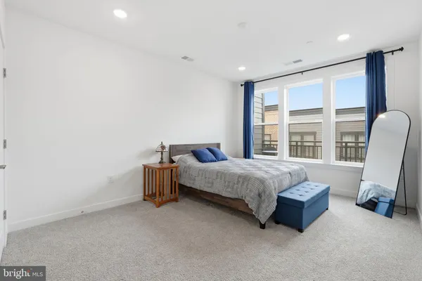 a bed room with a bed and a chair