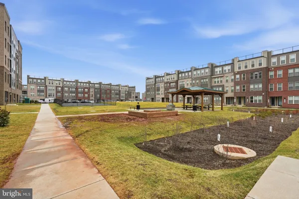 a view of swimming pool with outdoor seating and buildings in the background