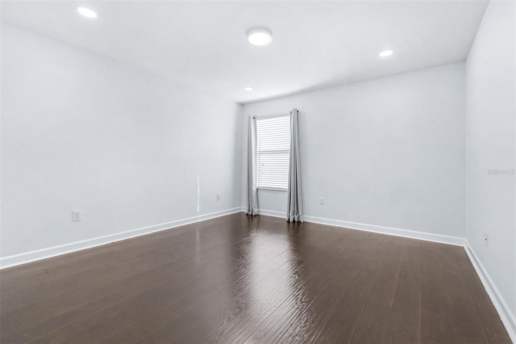1762 Hadden Hall Place Trinity, FL 34655 - Photo 26 of 49 a view of an empty room with wooden floor and a window