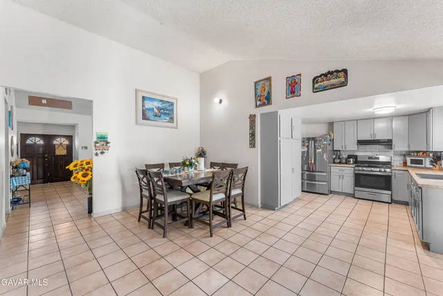 a kitchen with stainless steel appliances a refrigerator and a stove top oven