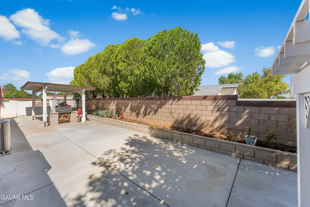 a view of a backyard with sitting area