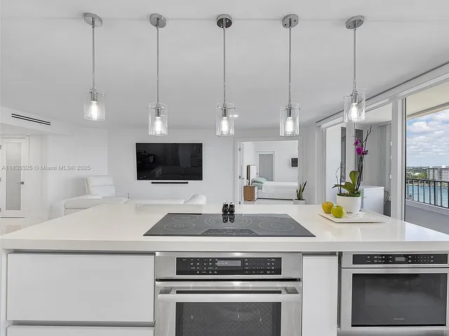 a kitchen with a sink a counter and chairs