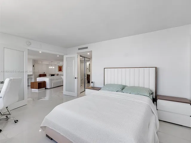 a large white bed in a white room