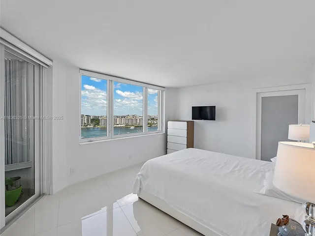 a large white bed in a white room