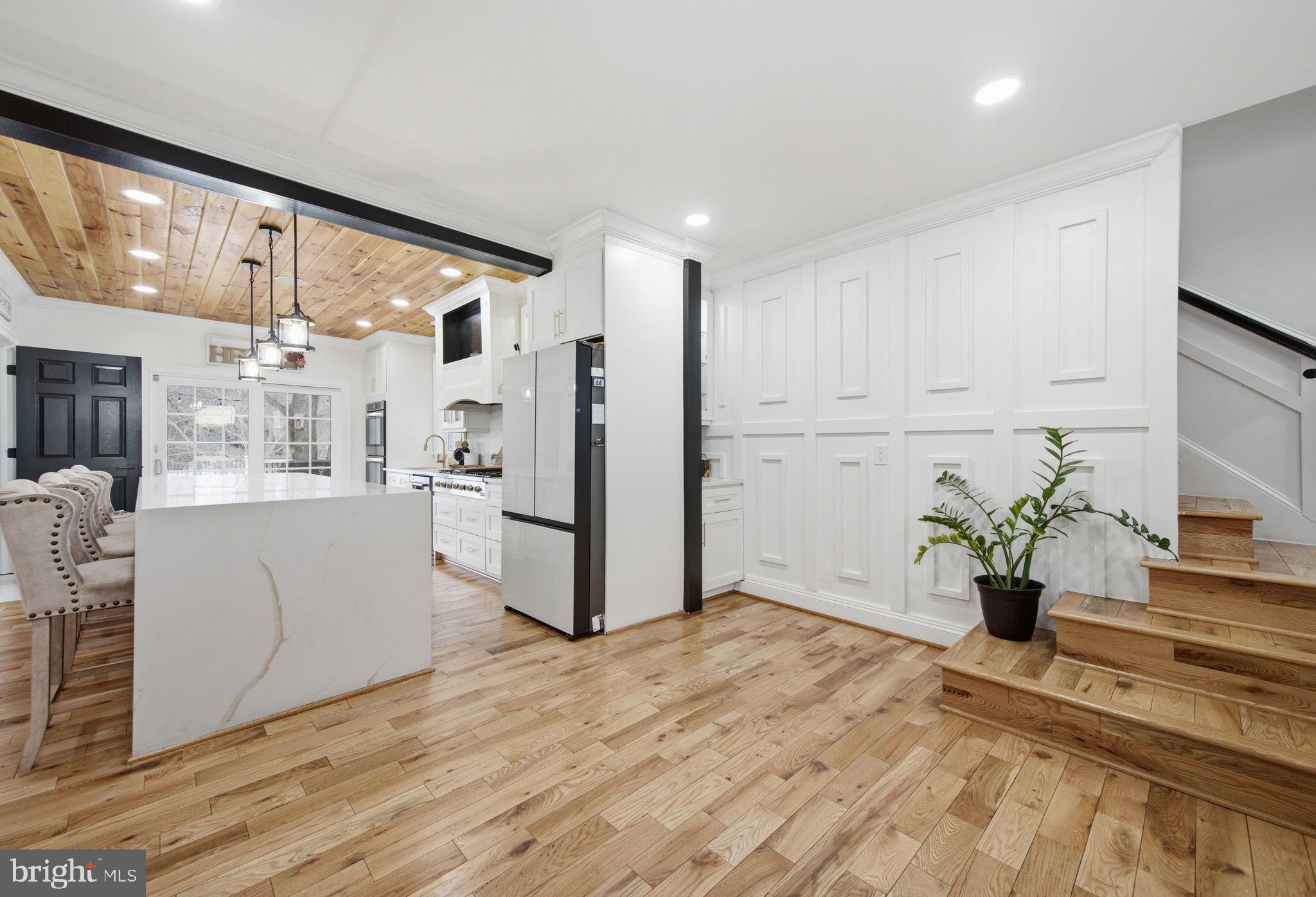 3524 Blenheim Road Phoenix, MD 21131 - Photo 18 of 61 a kitchen with white cabinets and wooden floor