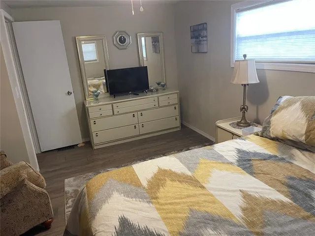 a bedroom with a bed and flat screen tv