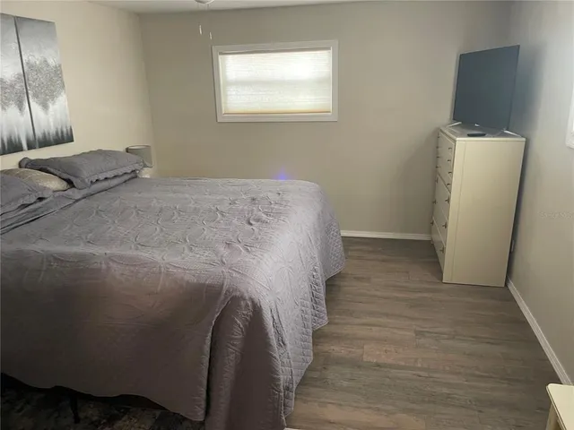 a bed sitting in a bedroom next to a window