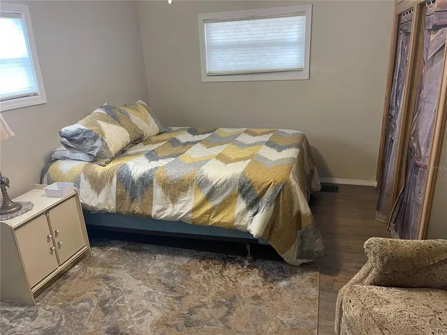 a bedroom with a bed and a dresser