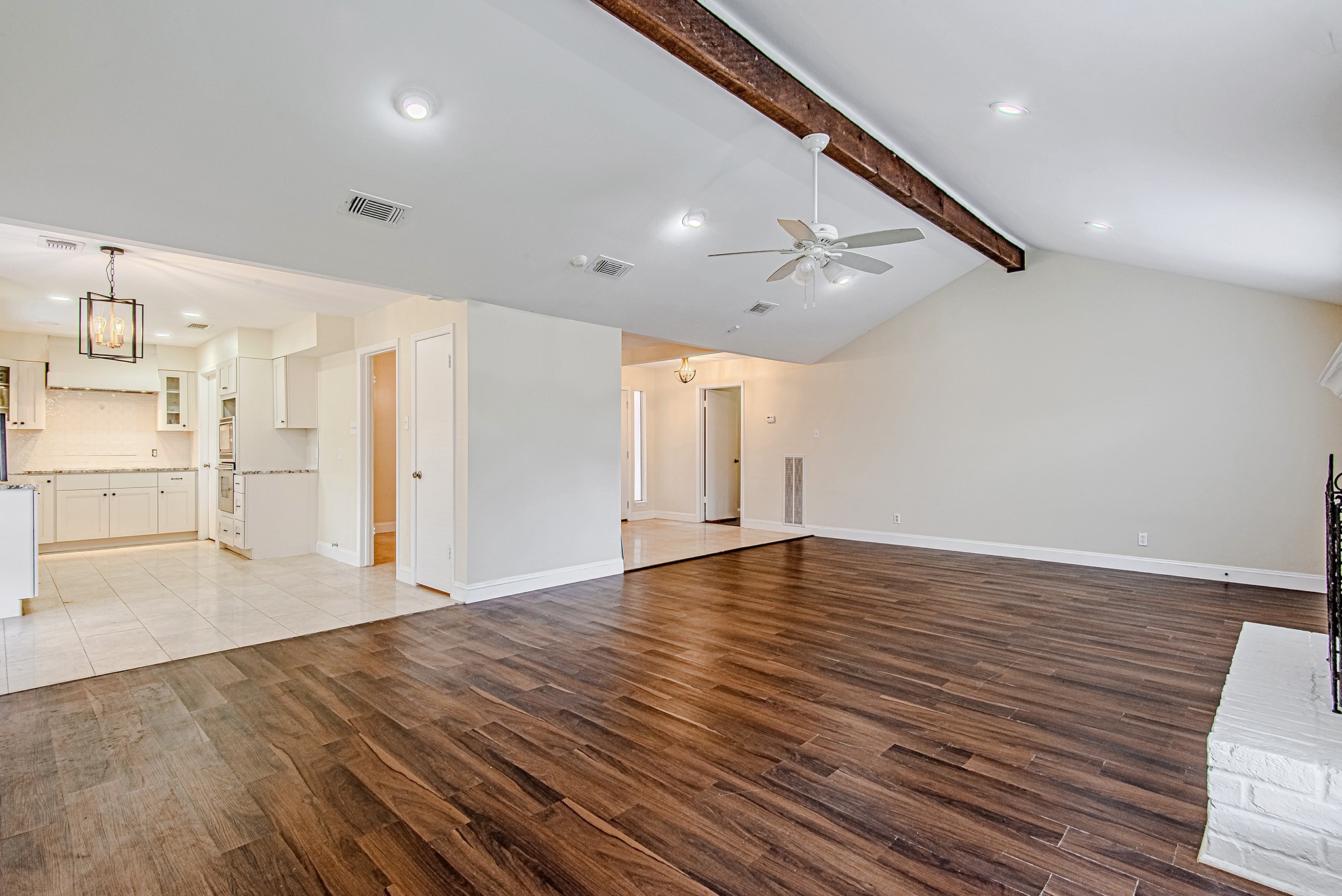 17811 Hawk Haven Lane Spring, TX 77379 - Photo 8 of 22 Another view of the large living area with statement ceiling beam detail and seamless flow to adjacent spaces.