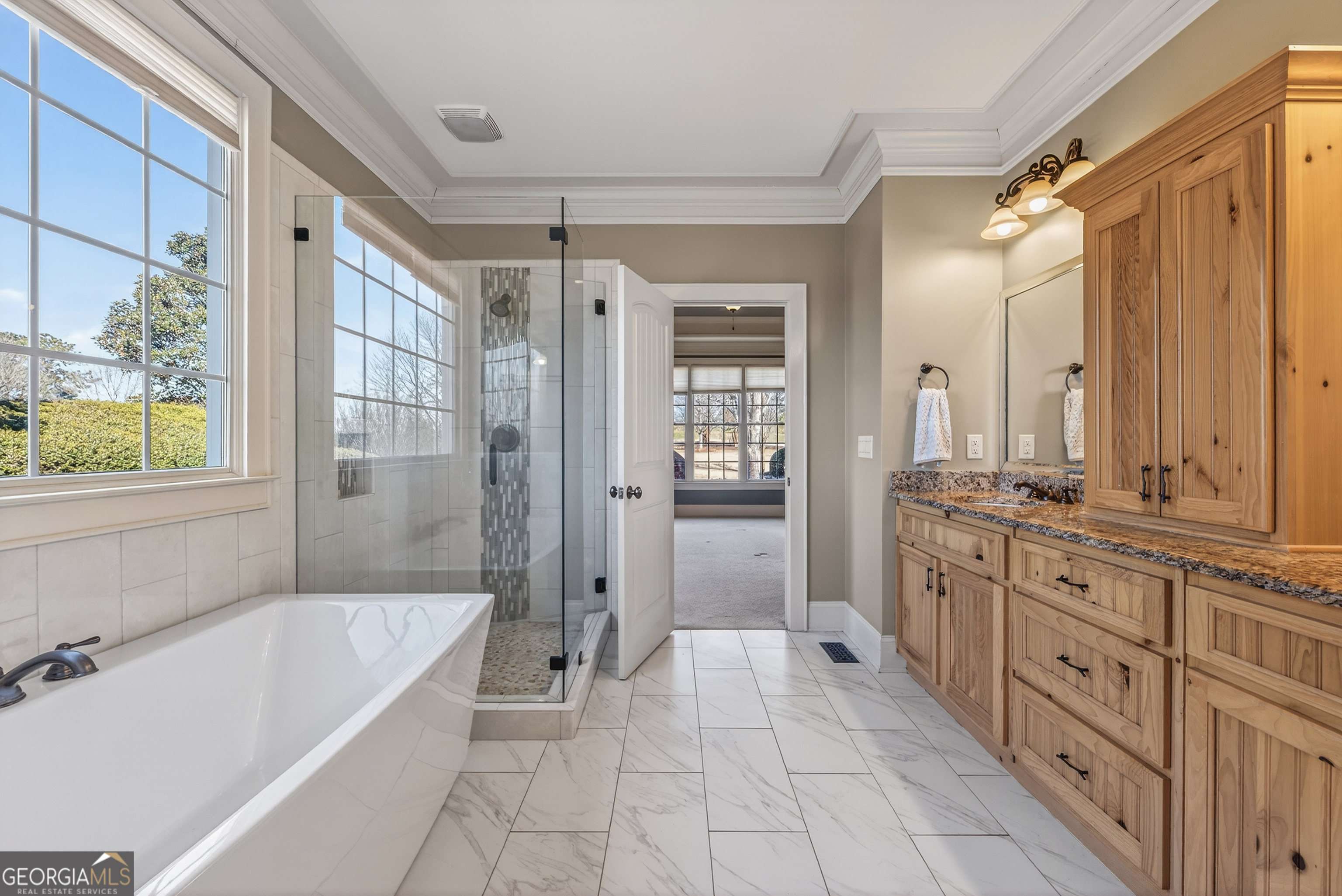 1000 Boxwood Place Madison, GA 30650 - Photo 32 of 75 a spacious bathroom with a granite countertop tub shower sink and mirror