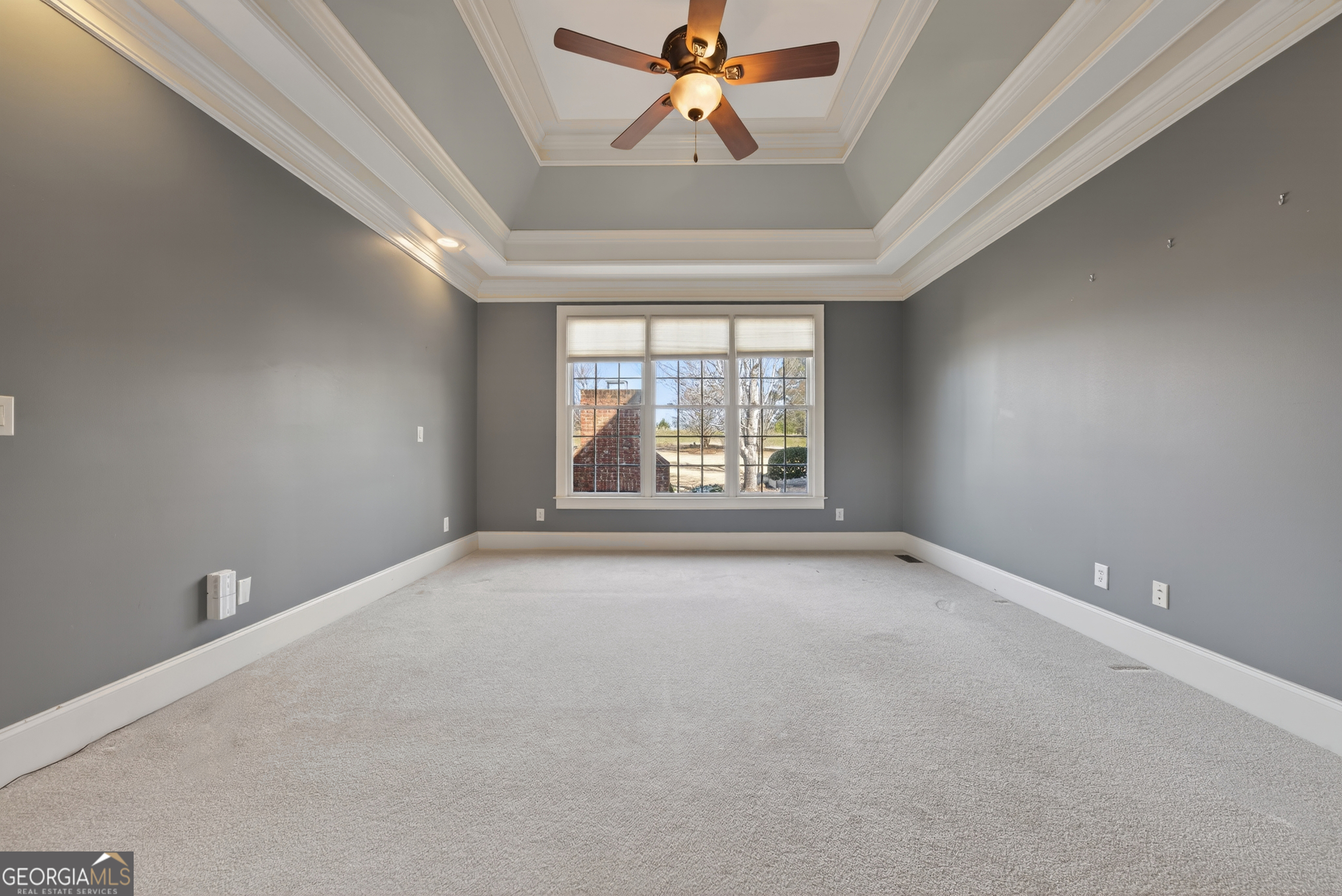 1000 Boxwood Place Madison, GA 30650 - Photo 35 of 75 an empty room with windows and ceiling fan