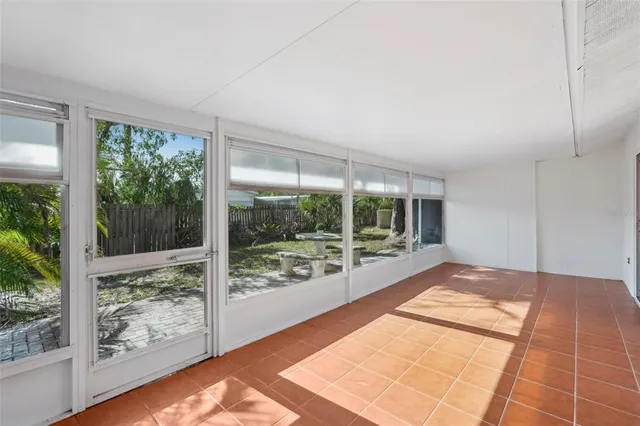 a view of an empty room with wooden floor and a floor to ceiling window