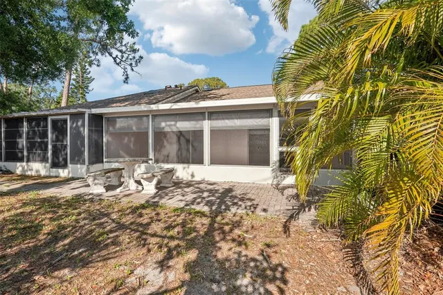 a view of a house with a large window and plants