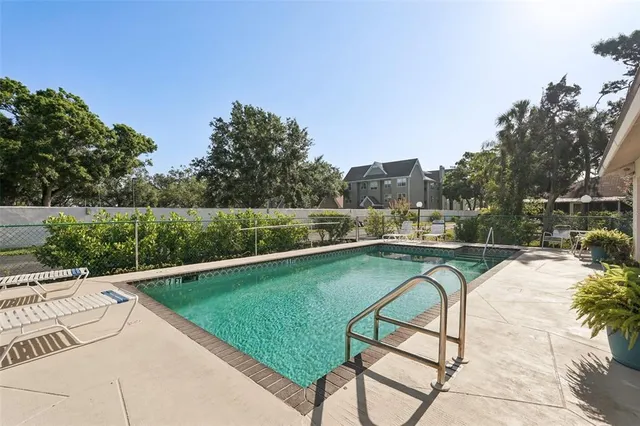 a view of a swimming pool with a patio