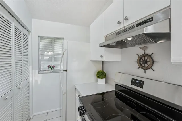 a kitchen with a stove and a refrigerator