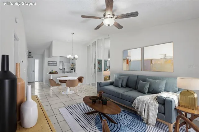 a living room with furniture a large window and a chandelier