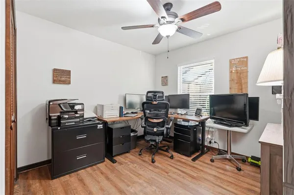 a view of a workspace with furniture and a window