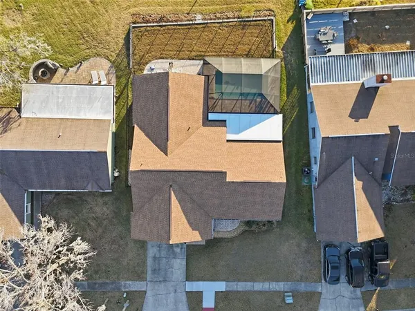 an aerial view of a house with outdoor space and a barbeque