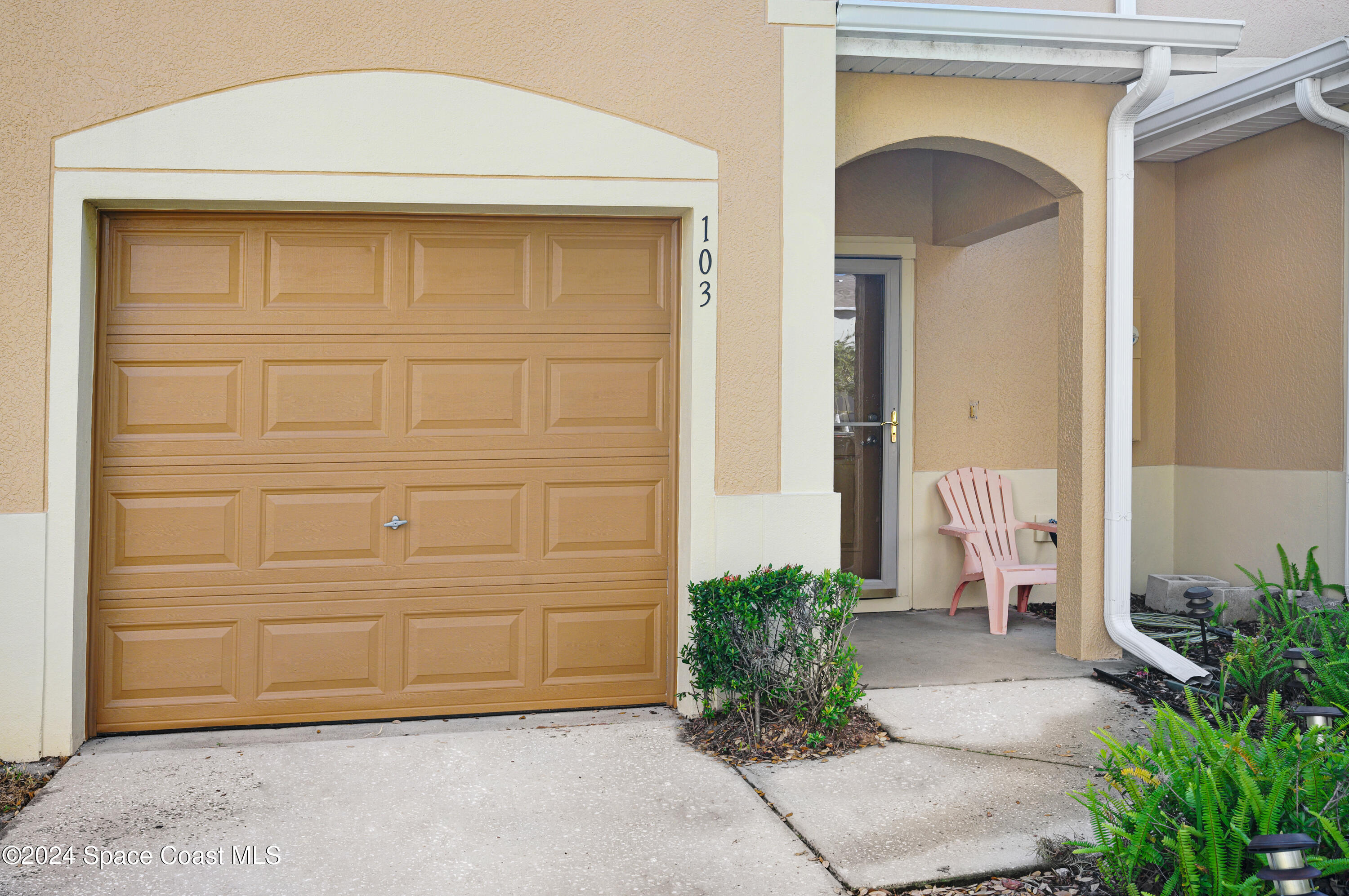 a front view of a house with garage