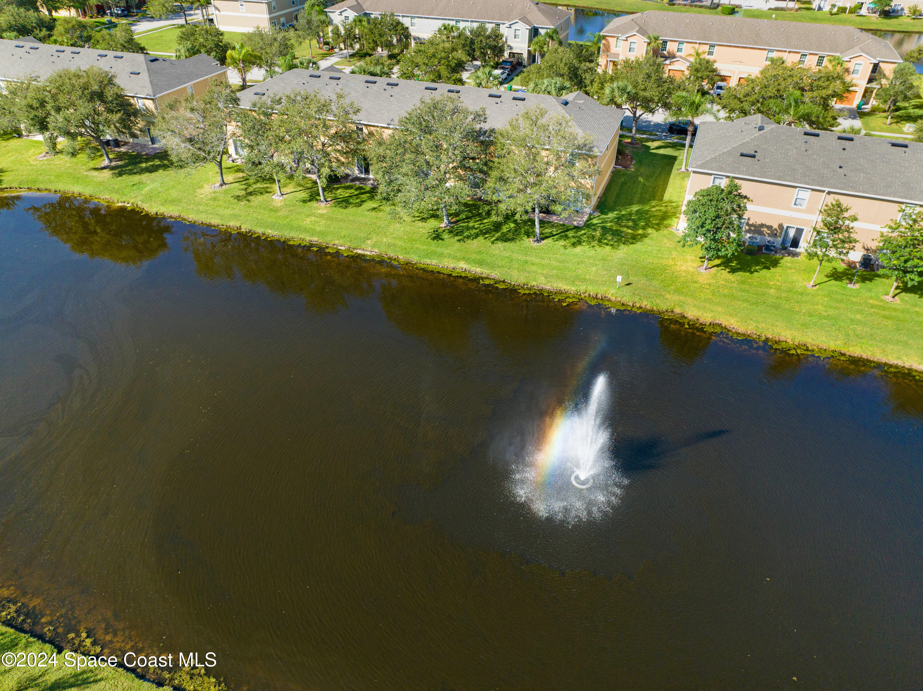 2785 Reston Street, Unit 103 Melbourne, FL 32935 - Photo 12 of 44 an aerial view of a houses with a lake view