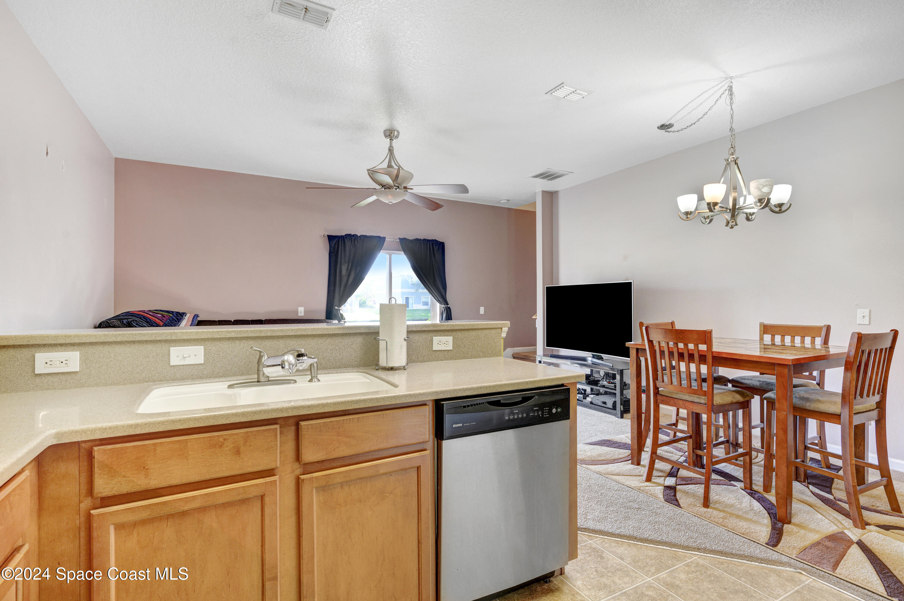 2785 Reston Street, Unit 103 Melbourne, FL 32935 - Photo 28 of 44 a kitchen with a table chairs stove and microwave