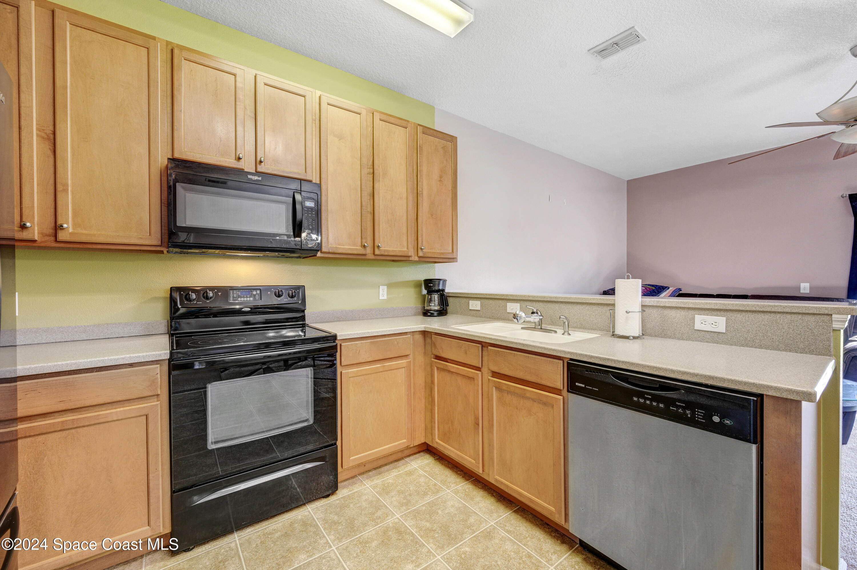 2785 Reston Street, Unit 103 Melbourne, FL 32935 - Photo 29 of 44 a kitchen with stainless steel appliances granite countertop a sink stove and microwave