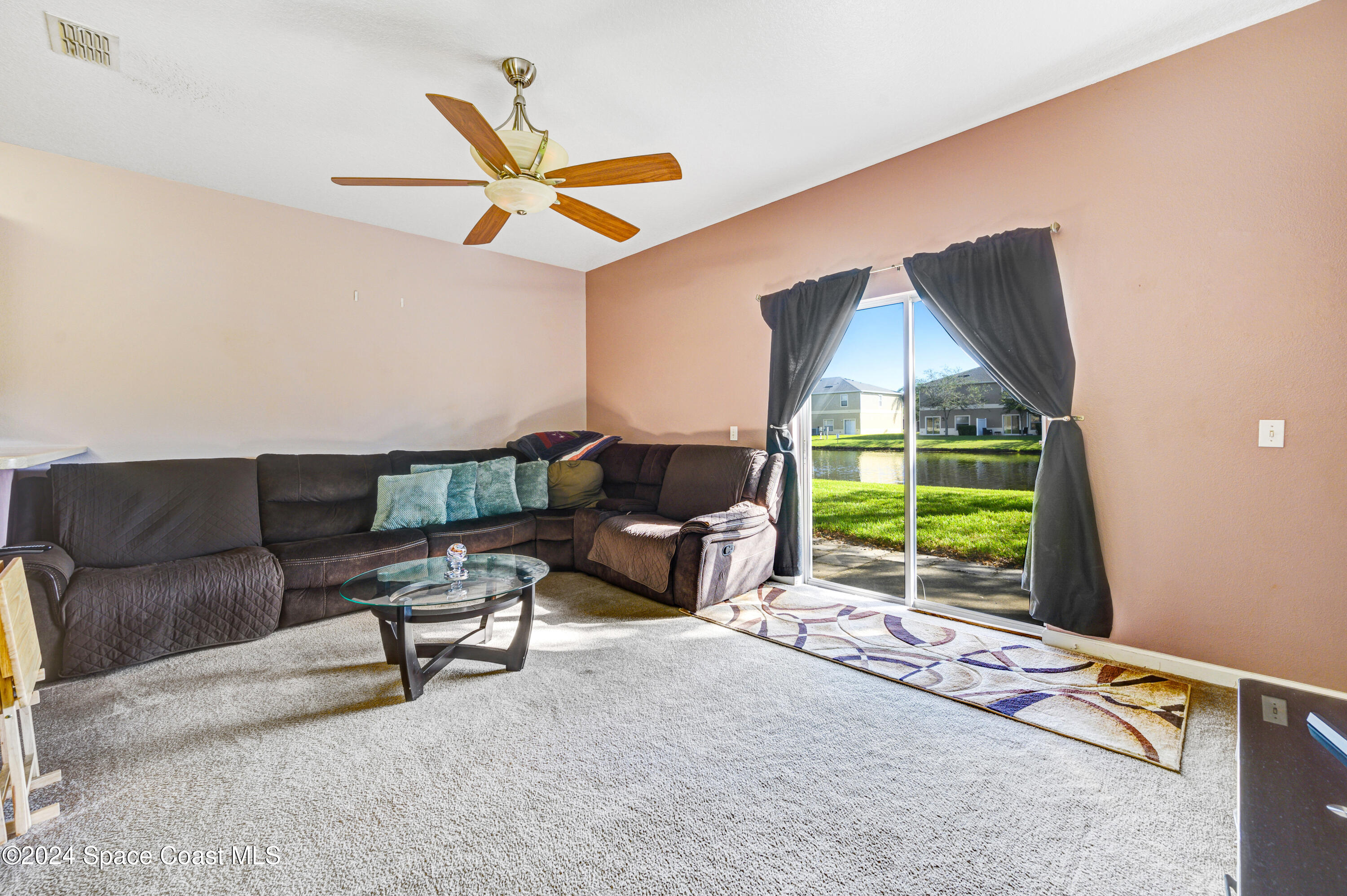2785 Reston Street, Unit 103 Melbourne, FL 32935 - Photo 33 of 44 a living room with furniture a window and a fireplace