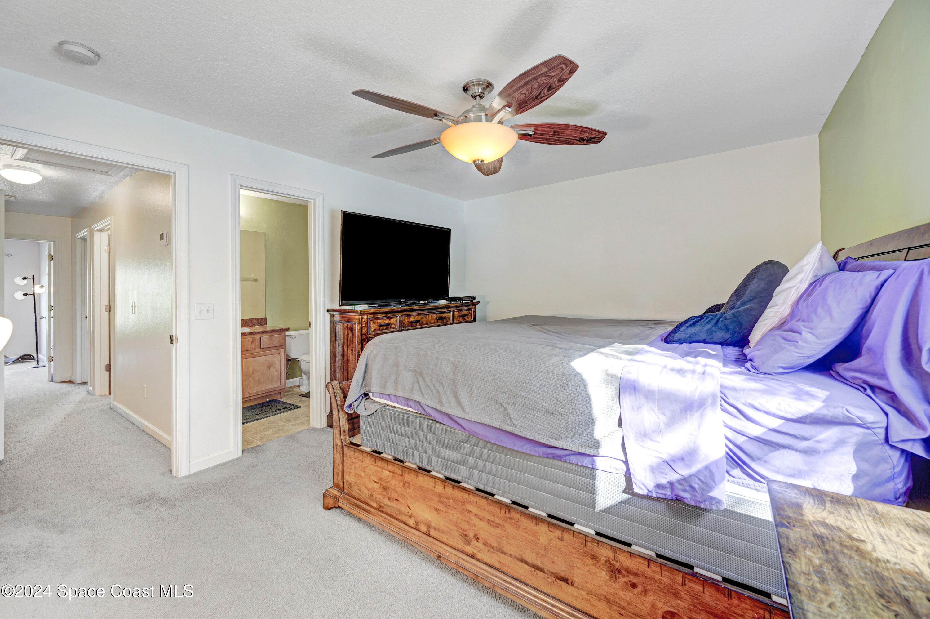 2785 Reston Street, Unit 103 Melbourne, FL 32935 - Photo 39 of 44 a bedroom with a bed and a flat screen tv