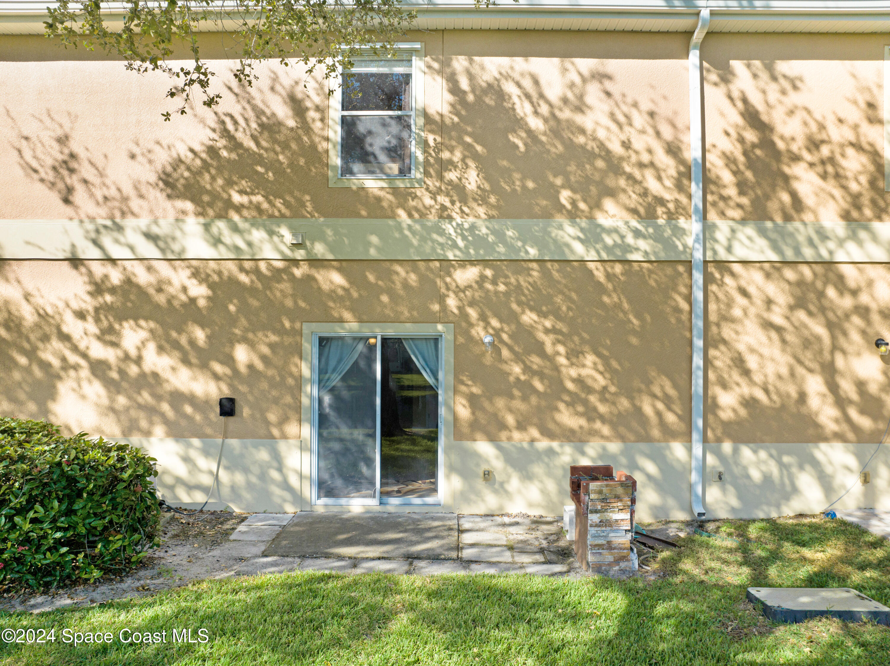 2785 Reston Street, Unit 103 Melbourne, FL 32935 - Photo 10 of 44 a front view of a house with a yard