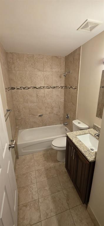 1940 Northwest 4th Court, Unit 14 Miami, FL 33136 - Photo 2 of 3 a bathroom with a granite countertop sink a toilet and bathtub