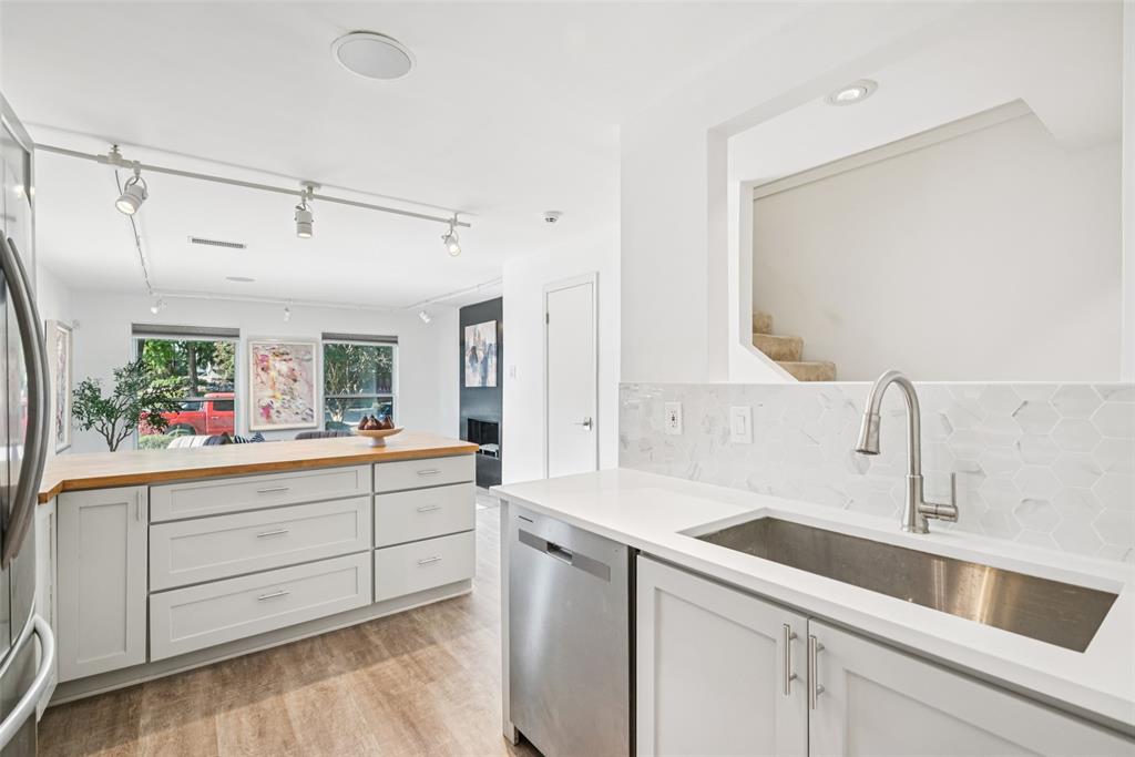 4102 Bowser Avenue, Unit 1 Dallas, TX 75219 - Photo 11 of 33 Expanded prep zone with quartz counters, new tile backsplash, and deep stainless sink enhances function and style.