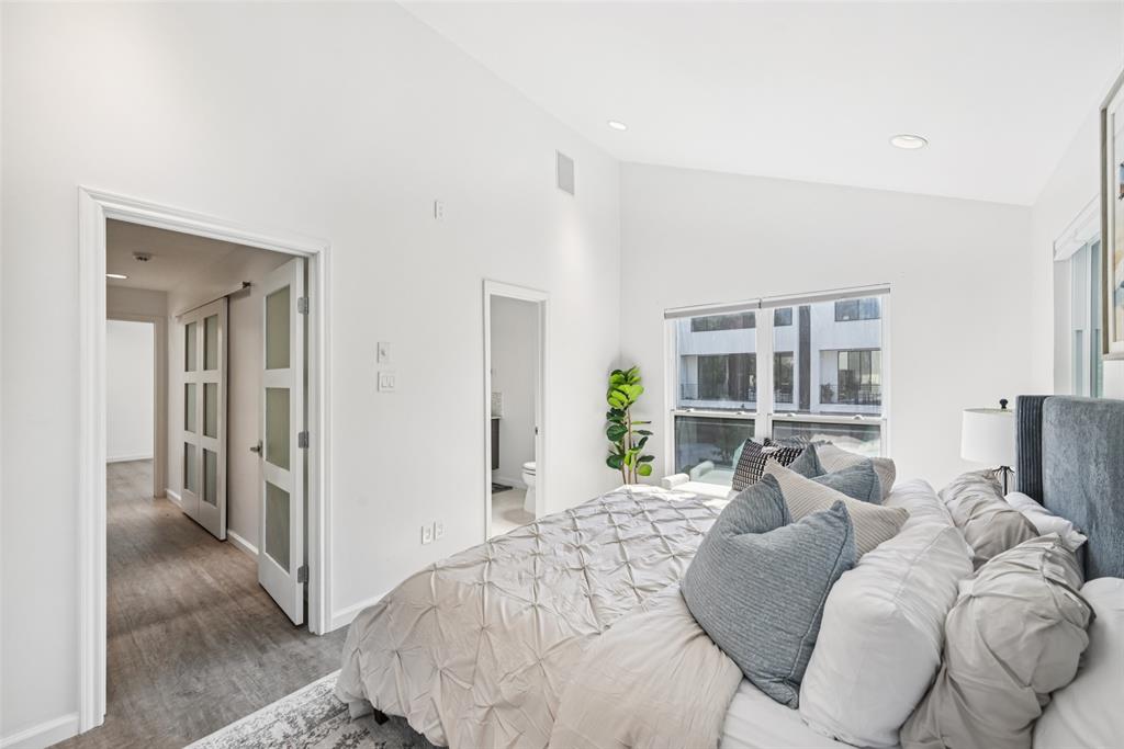 4102 Bowser Avenue, Unit 1 Dallas, TX 75219 - Photo 21 of 33 The spacious primary suite connects to a full ensuite bath and offers a serene retreat.