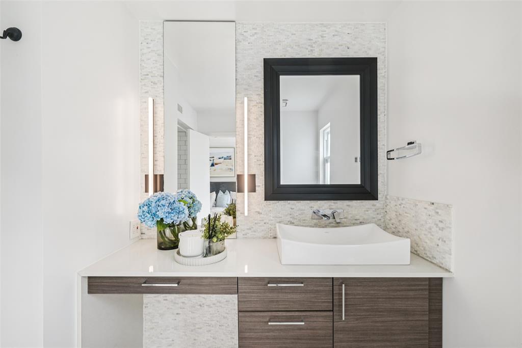 4102 Bowser Avenue, Unit 1 Dallas, TX 75219 - Photo 23 of 33 Modern vanity with vessel sink, quartz countertop, and sleek lighting creates a spa-like ambiance.