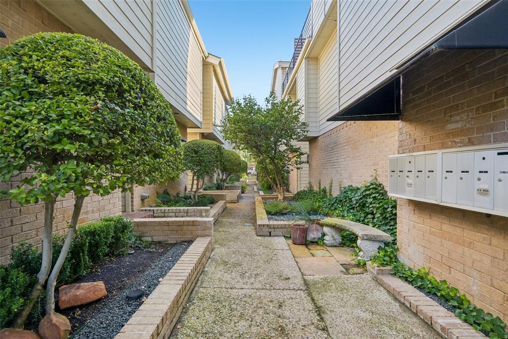4102 Bowser Avenue, Unit 1 Dallas, TX 75219 - Photo 31 of 33 Gated community walkway framed by manicured landscaping creates a peaceful entry experience.
