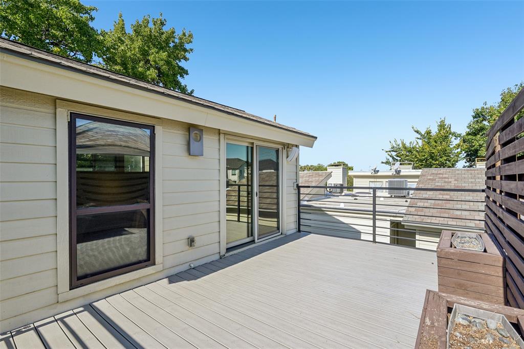 4102 Bowser Avenue, Unit 1 Dallas, TX 75219 - Photo 33 of 33 Elevated outdoor retreat with sleek railing and privacy screen captures sunlight and skyline glimpses.