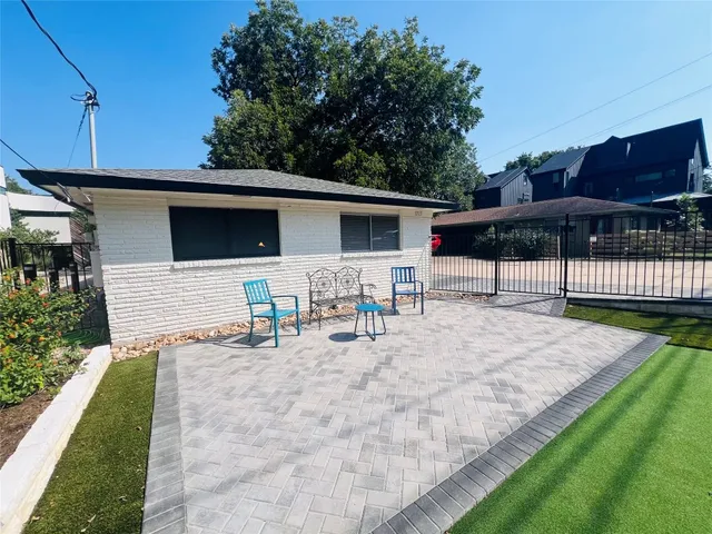 a view of a backyard with sitting area