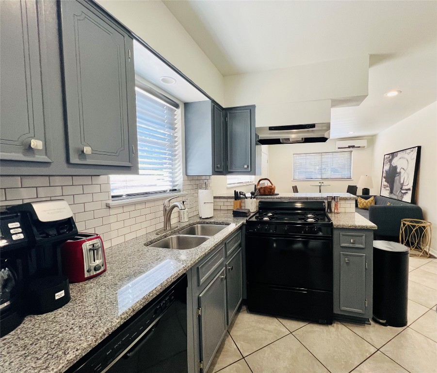 1715 Bluebonnet Lane, Unit A Austin, TX 78704 - Photo 6 of 13 a kitchen with granite countertop a sink stove and cabinets