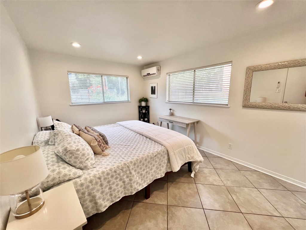 1715 Bluebonnet Lane, Unit A Austin, TX 78704 - Photo 8 of 13 a bedroom with a bed and window