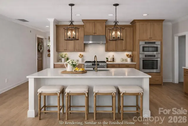 a kitchen with stainless steel appliances granite countertop a dining table chairs and stove
