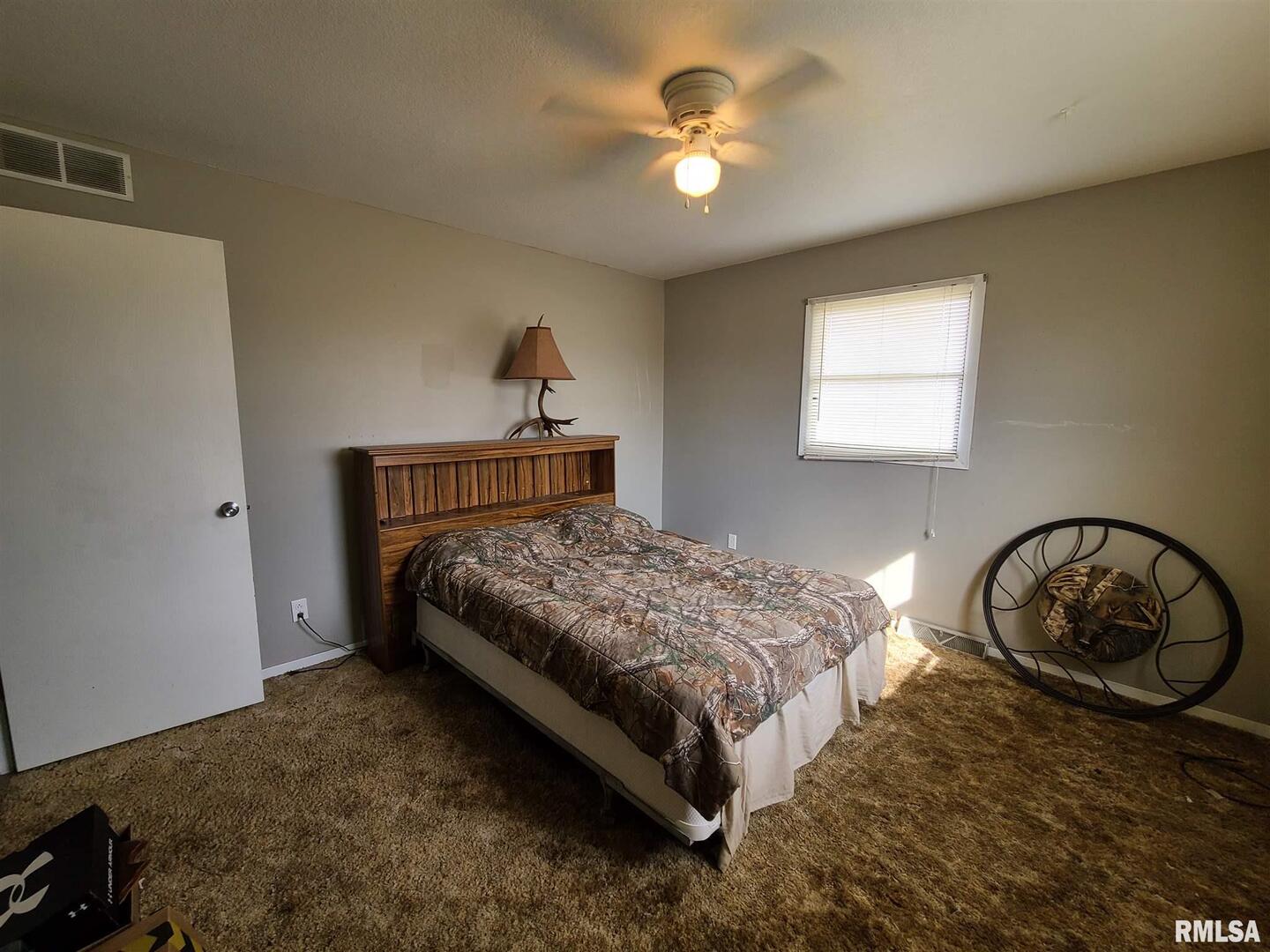 1564 East 300 N Road Cowden, IL 62422 - Photo 28 of 50 a bedroom with a bed and a chandelier