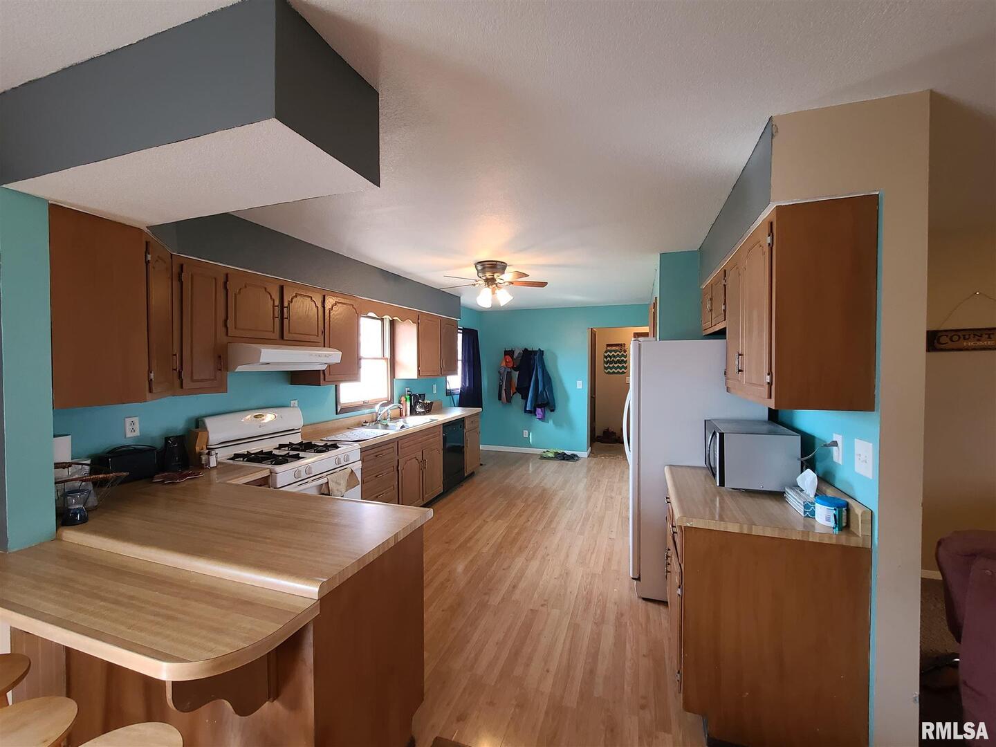 1564 East 300 N Road Cowden, IL 62422 - Photo 34 of 50 a kitchen with a table chairs refrigerator and a stove