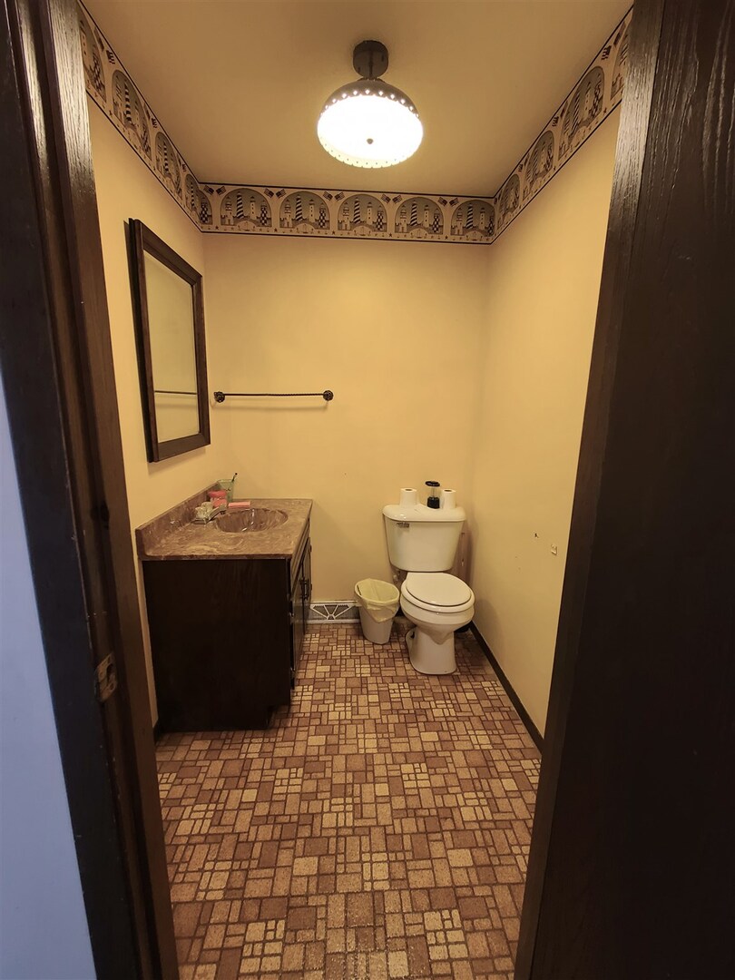 1564 East 300 N Road Cowden, IL 62422 - Photo 39 of 50 a bathroom with a sink a toilet and mirror
