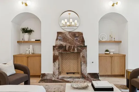 a living room with furniture and a mirror